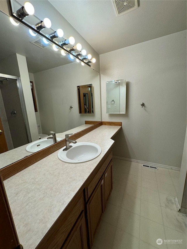 bathroom featuring walk in shower and vanity