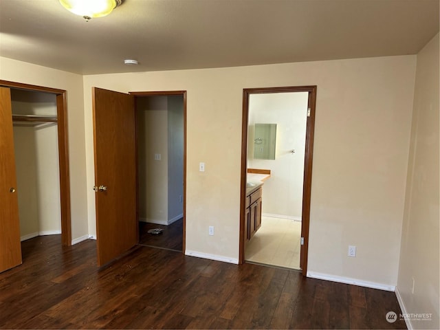 unfurnished bedroom with dark hardwood / wood-style flooring, connected bathroom, electric panel, and a closet