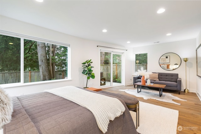 bedroom featuring access to exterior and light wood-type flooring