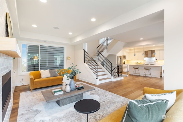 living room with a tray ceiling and hardwood / wood-style flooring