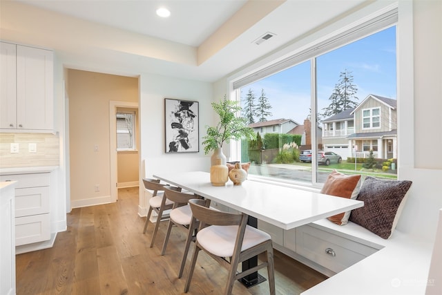 dining space featuring wood-type flooring, breakfast area, and plenty of natural light