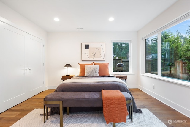 bedroom featuring hardwood / wood-style floors and a closet