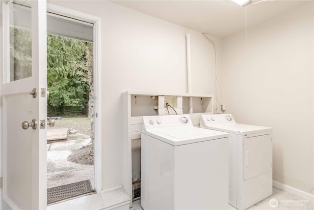 laundry room featuring laundry area, baseboards, and washer and dryer