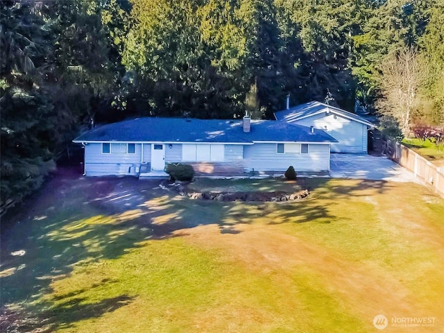 view of front of house with a front yard and fence