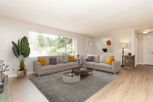 living room with light wood finished floors and baseboards