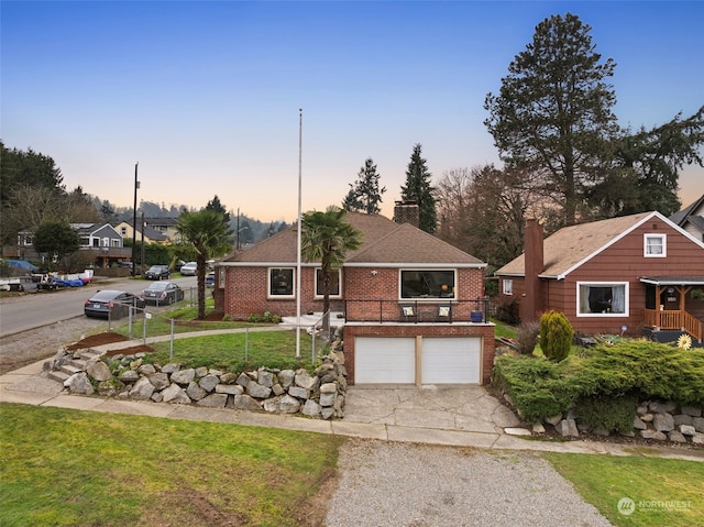 view of front facade with a yard and a garage