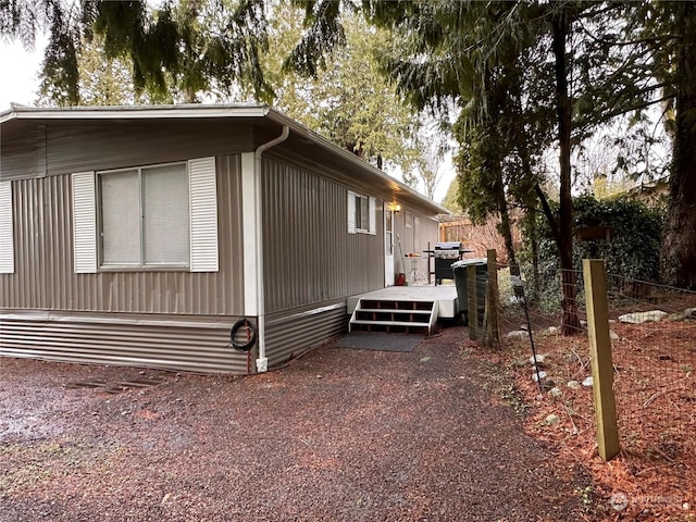 view of home's exterior with a wooden deck