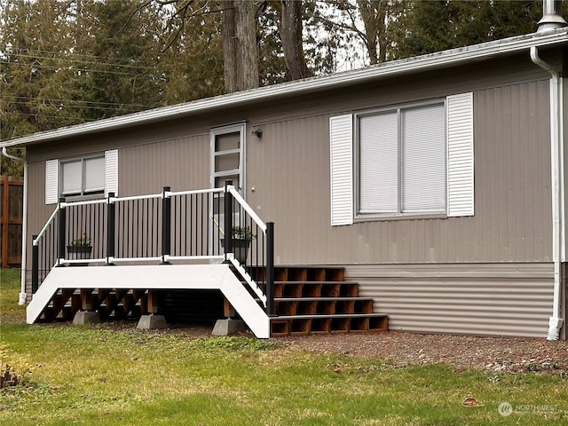 rear view of property featuring a lawn