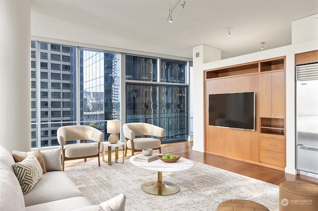 living room featuring dark hardwood / wood-style floors and a wall of windows