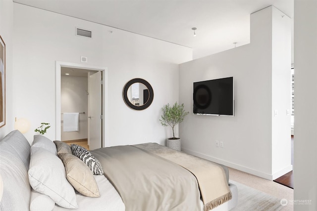 carpeted bedroom with ensuite bath