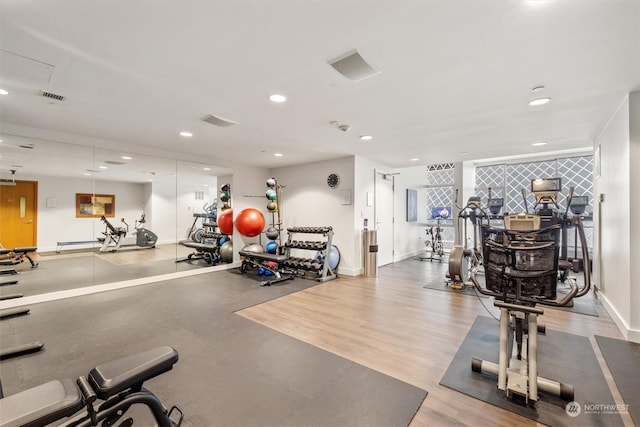 exercise room with hardwood / wood-style flooring