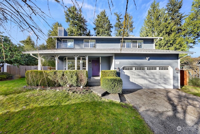 view of front of home with a front lawn and a garage