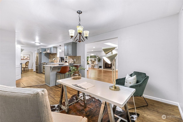 dining space with light wood-type flooring and a chandelier