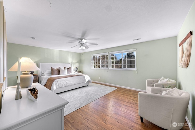 bedroom with ceiling fan and hardwood / wood-style floors