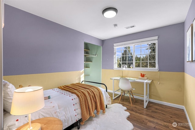 bedroom with dark hardwood / wood-style flooring