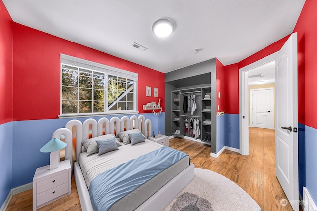 bedroom featuring hardwood / wood-style flooring and a closet