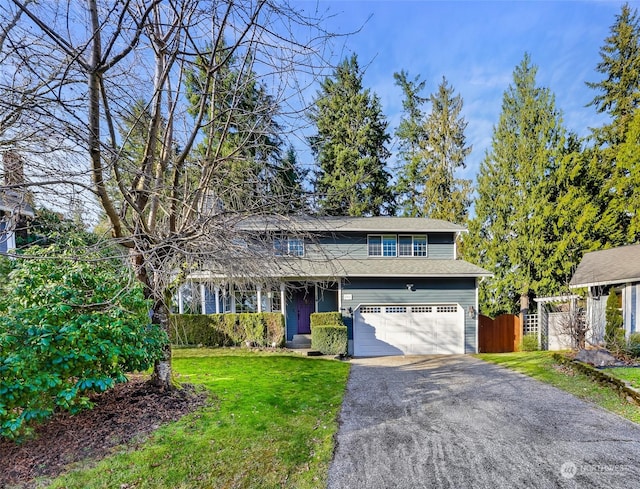 view of front property featuring a front yard and a garage