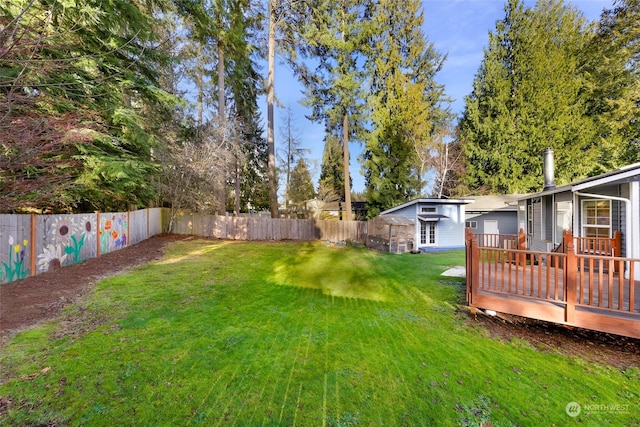 view of yard with a wooden deck and an outdoor structure