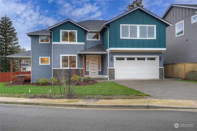 craftsman house with a garage and a front lawn