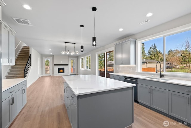 kitchen featuring gray cabinetry, visible vents, and a sink