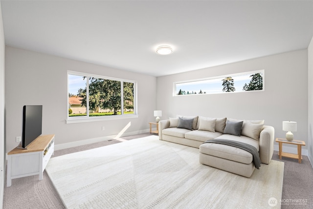 carpeted living area with baseboards