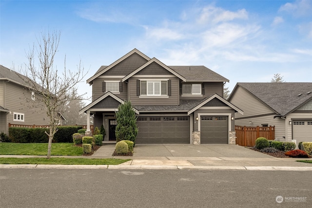 craftsman house with a front lawn and a garage