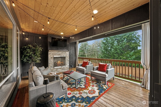 deck featuring an outdoor living space with a fireplace