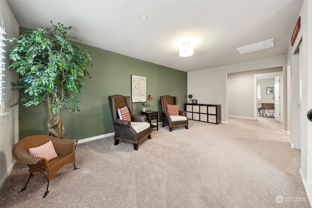 living area featuring light colored carpet