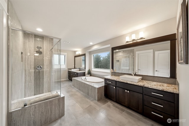 bathroom with vanity and independent shower and bath