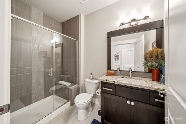 bathroom featuring an enclosed shower, vanity, toilet, and tile patterned flooring