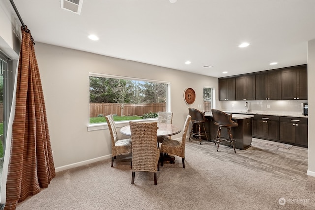 carpeted dining room with sink