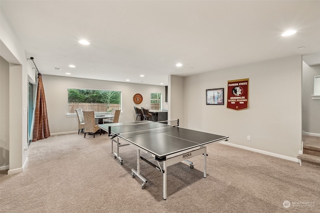 recreation room featuring light carpet