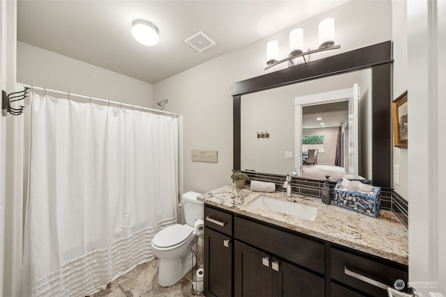 bathroom with vanity, toilet, and curtained shower