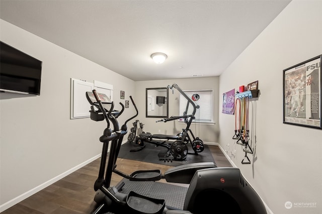 workout area with dark wood-type flooring