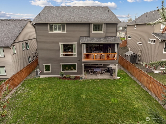 rear view of house featuring a lawn, a patio area, and cooling unit