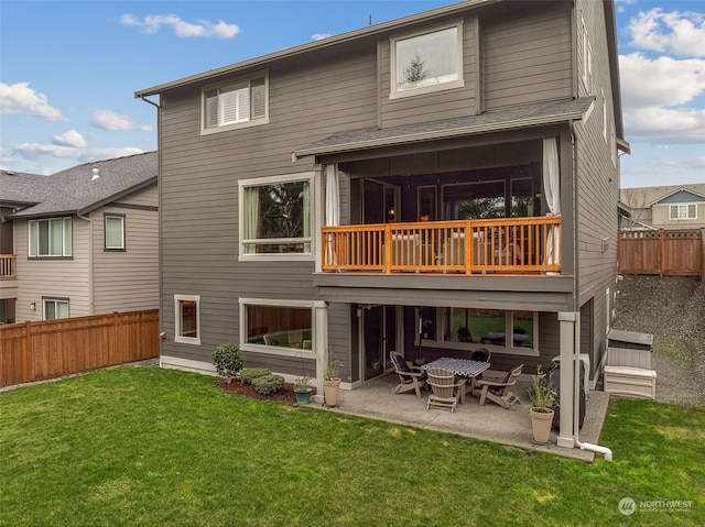 rear view of house featuring a patio area and a yard