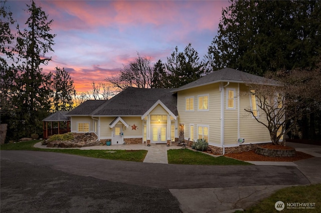 view of front of house with concrete driveway and french doors