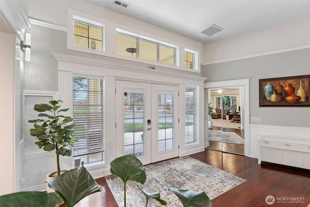 doorway featuring french doors, dark wood-type flooring, and visible vents