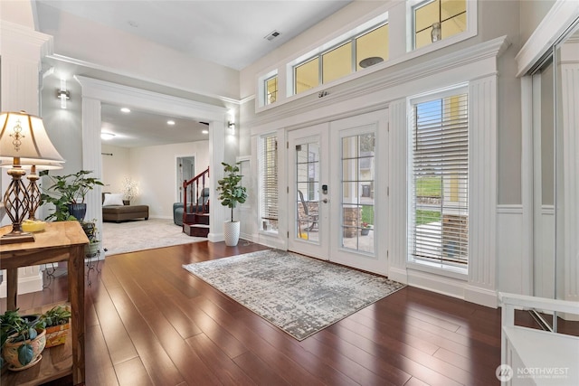 entryway with visible vents, baseboards, wood-type flooring, stairs, and french doors