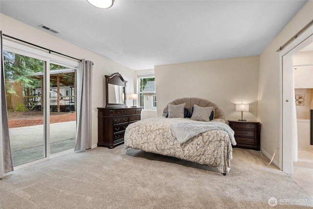 bedroom featuring access to exterior, light colored carpet, visible vents, connected bathroom, and baseboards