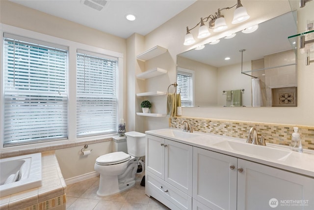 bathroom with tile patterned flooring, tasteful backsplash, visible vents, and a sink