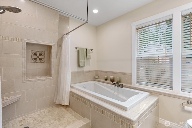 bathroom featuring a tile shower and a jetted tub