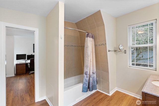 full bath featuring shower / bath combination with curtain, wood finished floors, vanity, and baseboards