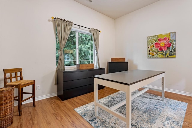 office featuring light wood-type flooring, visible vents, and baseboards