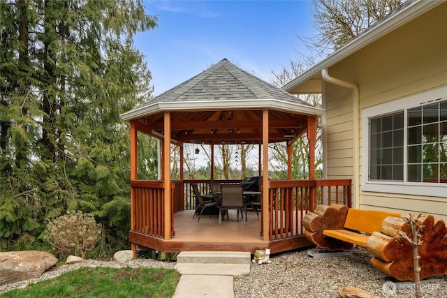 deck featuring outdoor dining space and a gazebo