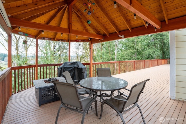 deck with outdoor dining space and area for grilling