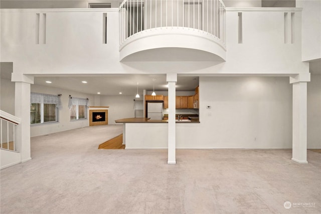 interior space with white fridge and light colored carpet