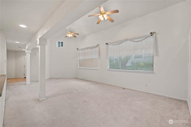 carpeted spare room featuring ceiling fan