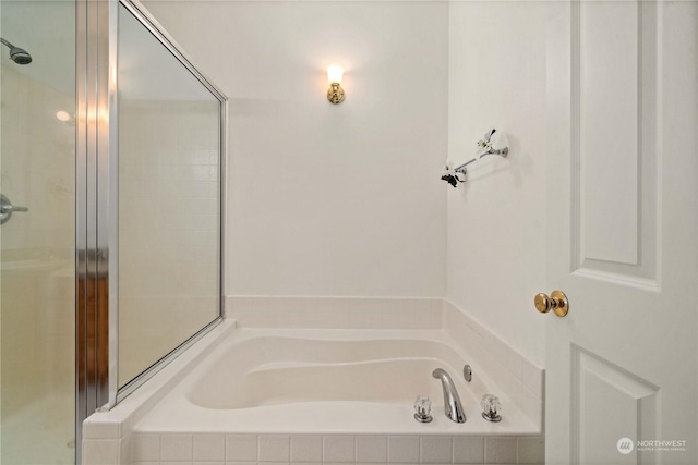 bathroom featuring separate shower and tub