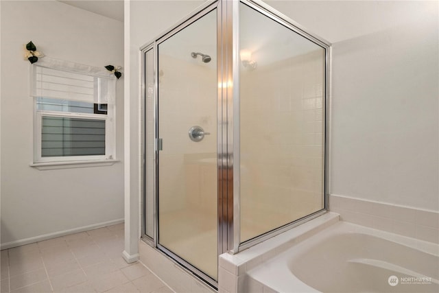 bathroom featuring tile patterned floors and separate shower and tub